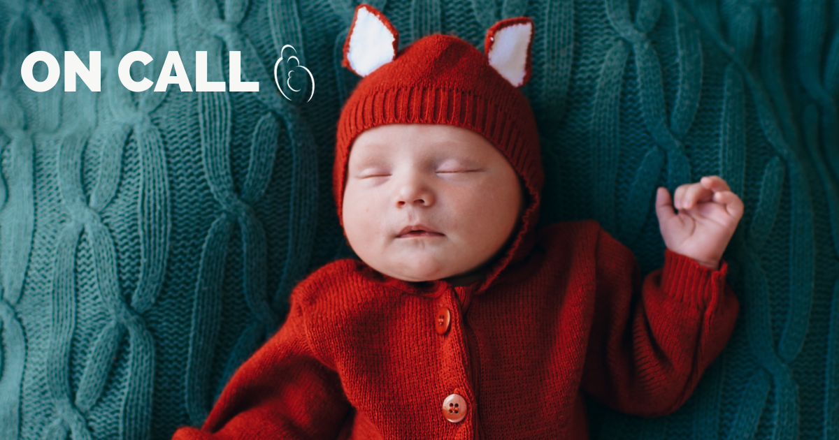 newborn baby with a knitted fox sweater